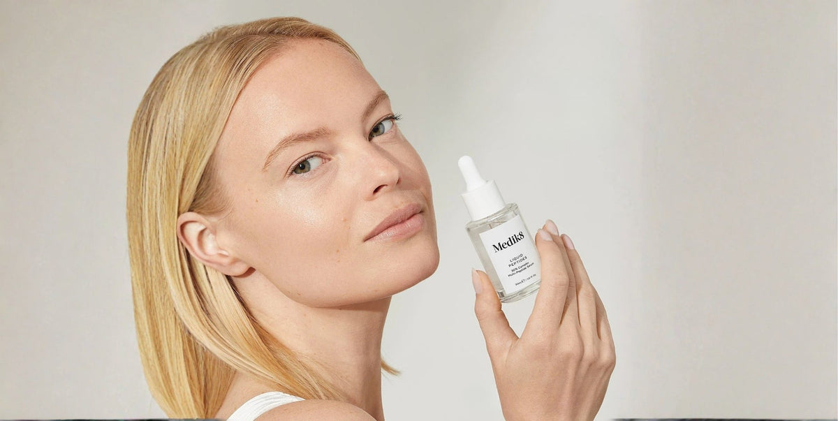 A woman holds a bottle of Liquid Peptides serum. Text on the right states, "Proven to smooth the look of fine lines and wrinkles in just 7 Days*." A footnote states this is from an independent consumer study.